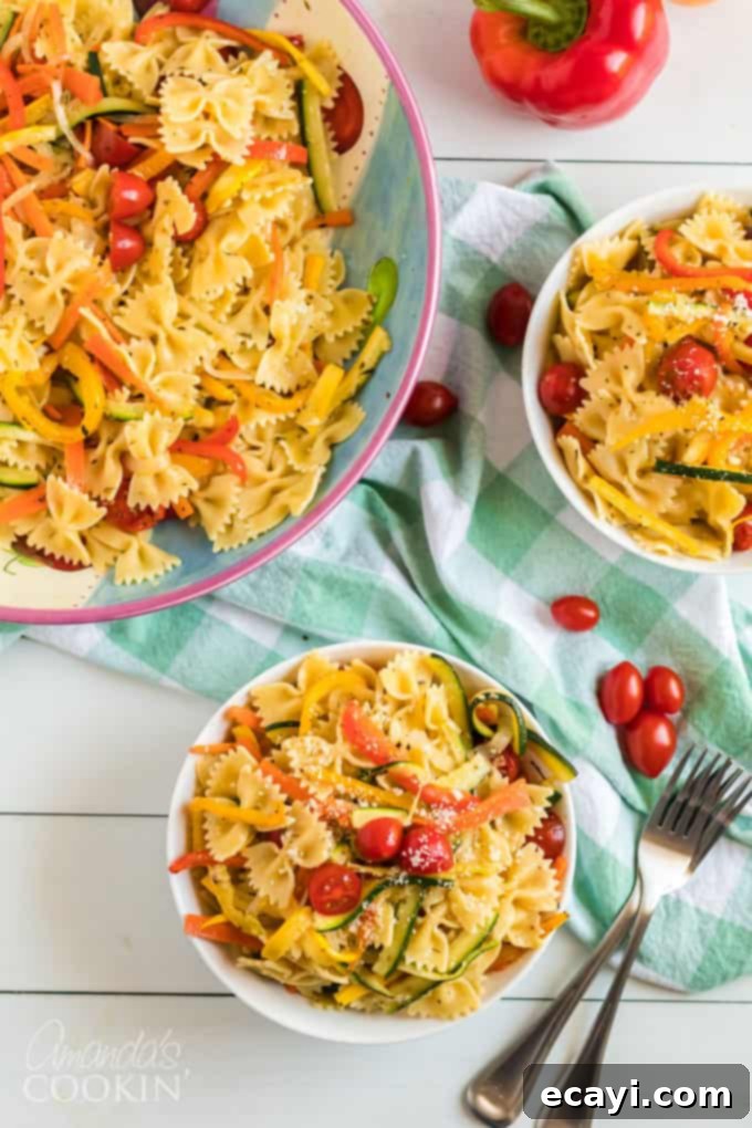 Pasta Primavera is a simple dish, ideal for weeknights, full of fresh vegetables and light on the sauce. A family friendly meal you'll love. #pastaprimavera #pastarecipes #vegetarian #zucchini #bellpeppers #dinner #dinnerrecipes #meatlessmondays two bowls of pasta primavera on a table