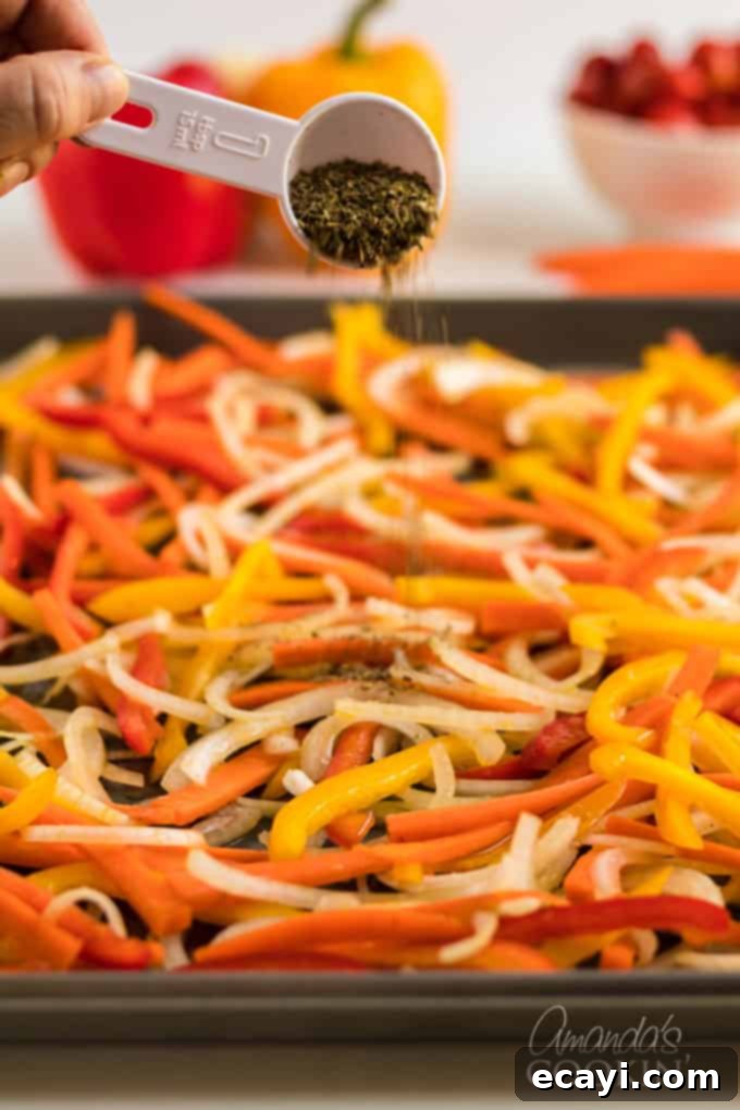 Pasta Primavera is a simple dish, ideal for weeknights, full of fresh vegetables and light on the sauce. A family friendly meal you'll love. #pastaprimavera #pastarecipes #vegetarian #zucchini #bellpeppers #dinner #dinnerrecipes #meatlessmondays sprinkling dried herbs onto fresh vegetables