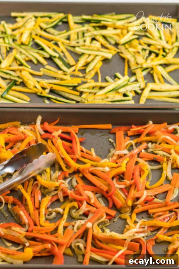 Pasta Primavera is a simple dish, ideal for weeknights, full of fresh vegetables and light on the sauce. A family friendly meal you'll love. #pastaprimavera #pastarecipes #vegetarian #zucchini #bellpeppers #dinner #dinnerrecipes #meatlessmondays rongs picking up roasted vegetables off pan