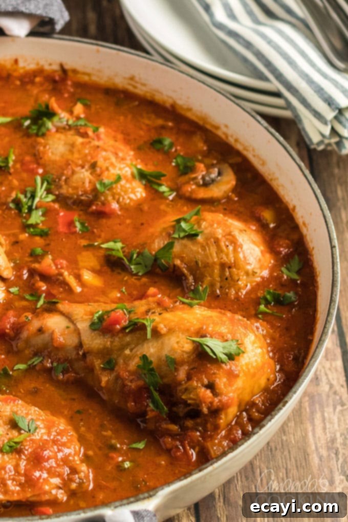 Classic Stovetop Chicken Cacciatore, featuring tender chicken stewed with vibrant onions, bell peppers, garlic, and capers in a rich tomato sauce. A perfect slow-cooked Italian comfort food for family dinners. #stovetopdinner #weeknightmeals #dinnerrecipes #chicken #chickencacciatore #bellpeppers #chickendinner #italianfood #comfortfood chicken cacciatore in a pan