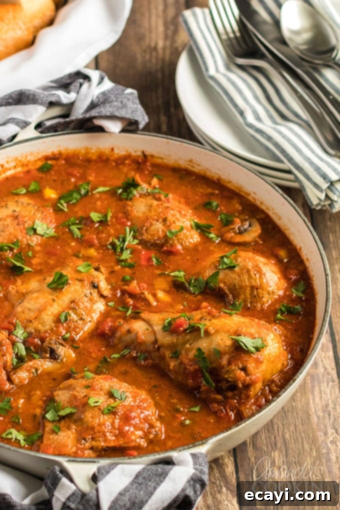Finished Stovetop Chicken Cacciatore in a skillet, ready to serve. This classic Italian stew features perfectly tender chicken in a savory sauce with bell peppers, onions, garlic, and capers. #chickencacciatore #stovetoprecipe #comfortfood #italianfood #dinneridea chicken cacciatore in a skillet