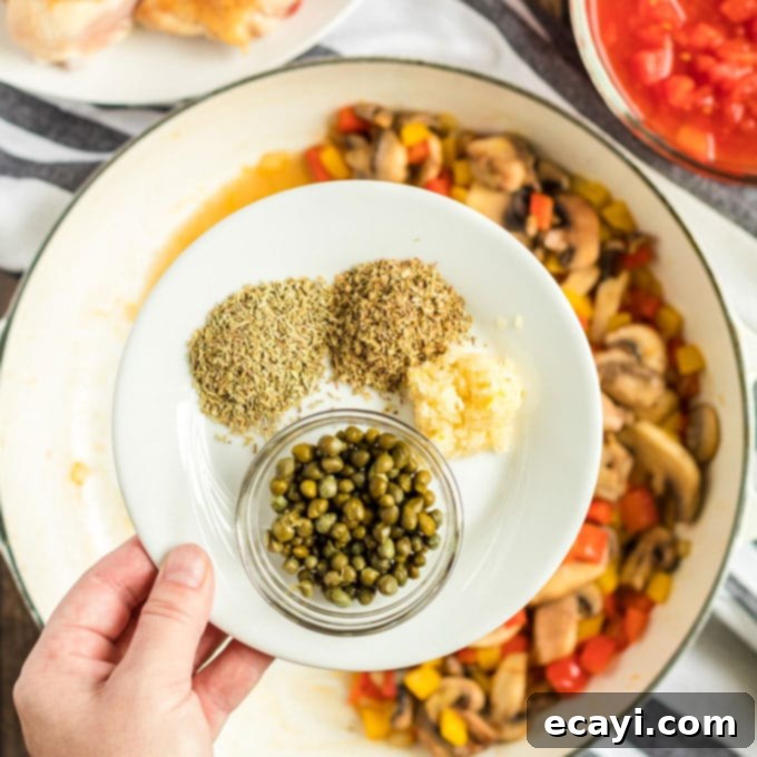 Adding aromatic dried Italian herbs, minced garlic, and capers to the sautéed vegetables for Chicken Cacciatore, enriching the sauce's flavor. #herbs #garlic #capers #flavorbuilding dish with dried herbs and garlic
