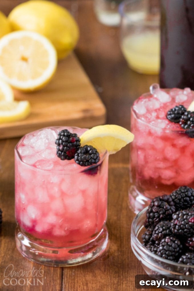 How to Make the Perfect Bramble Cocktail for Your Next Summer Party Refreshing Bramble cocktail in a rock glass, perfectly garnished with fresh blackberries and a lemon slice, sitting on ice cubes for a cool summer drink.