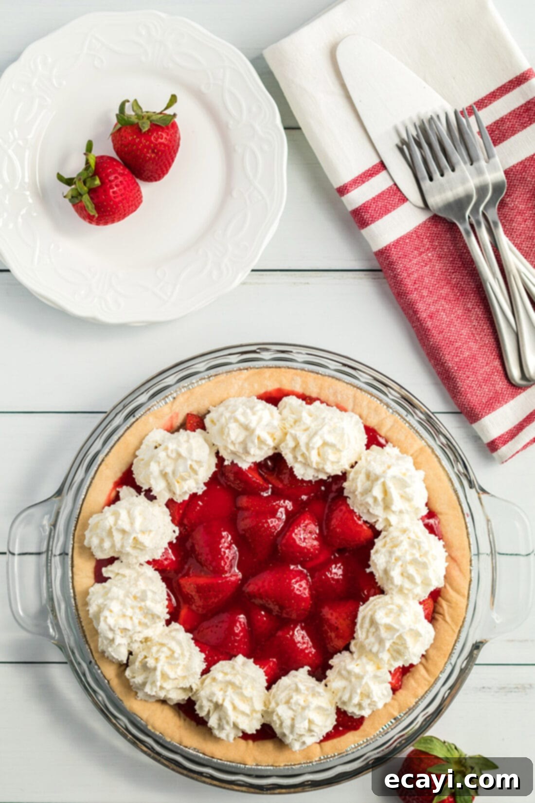 Grandma's Easy Jello Strawberry Pie Recipe: Perfectly set, fresh, and delicious, ideal for any occasion. A beautifully decorated strawberry pie, generously topped with swirls of homemade whipped cream, ready to be served as a delightful summer dessert.