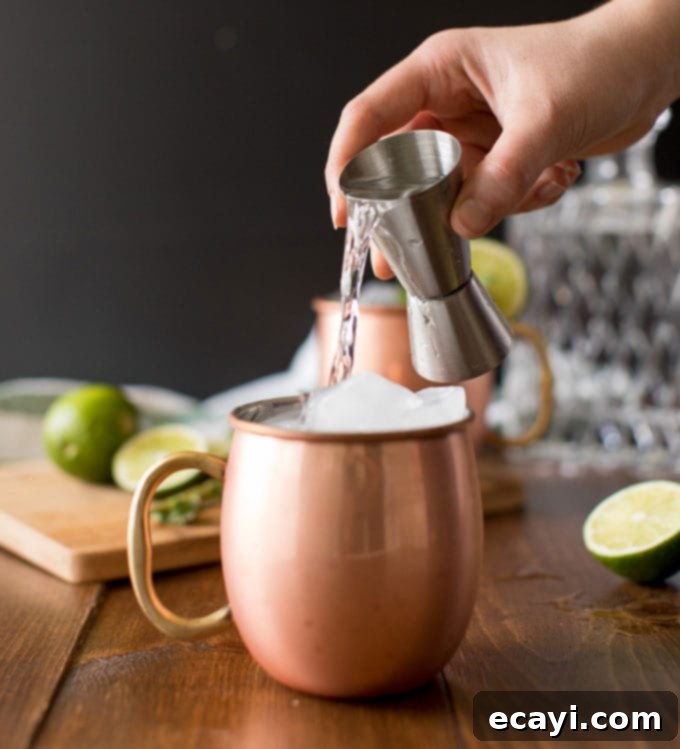 Copper Kick 3 pouring vodka over ice in copper mug
