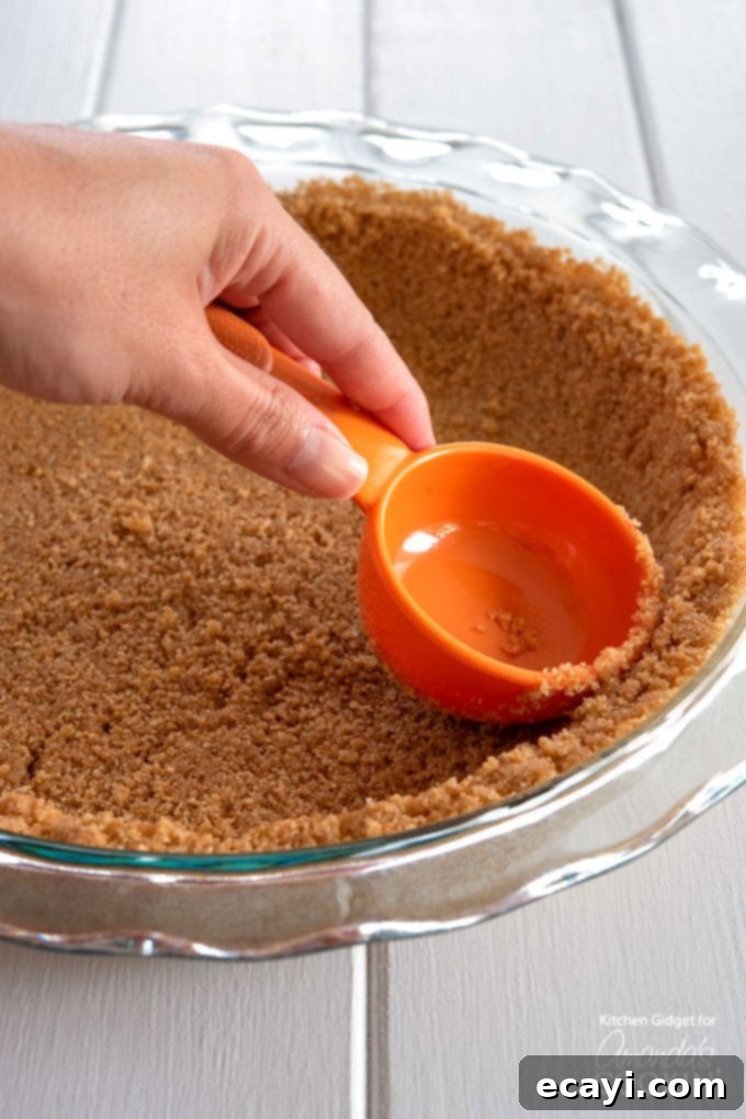 Effortless Peanut Butter Bliss 4 pressing down the graham cracker crust