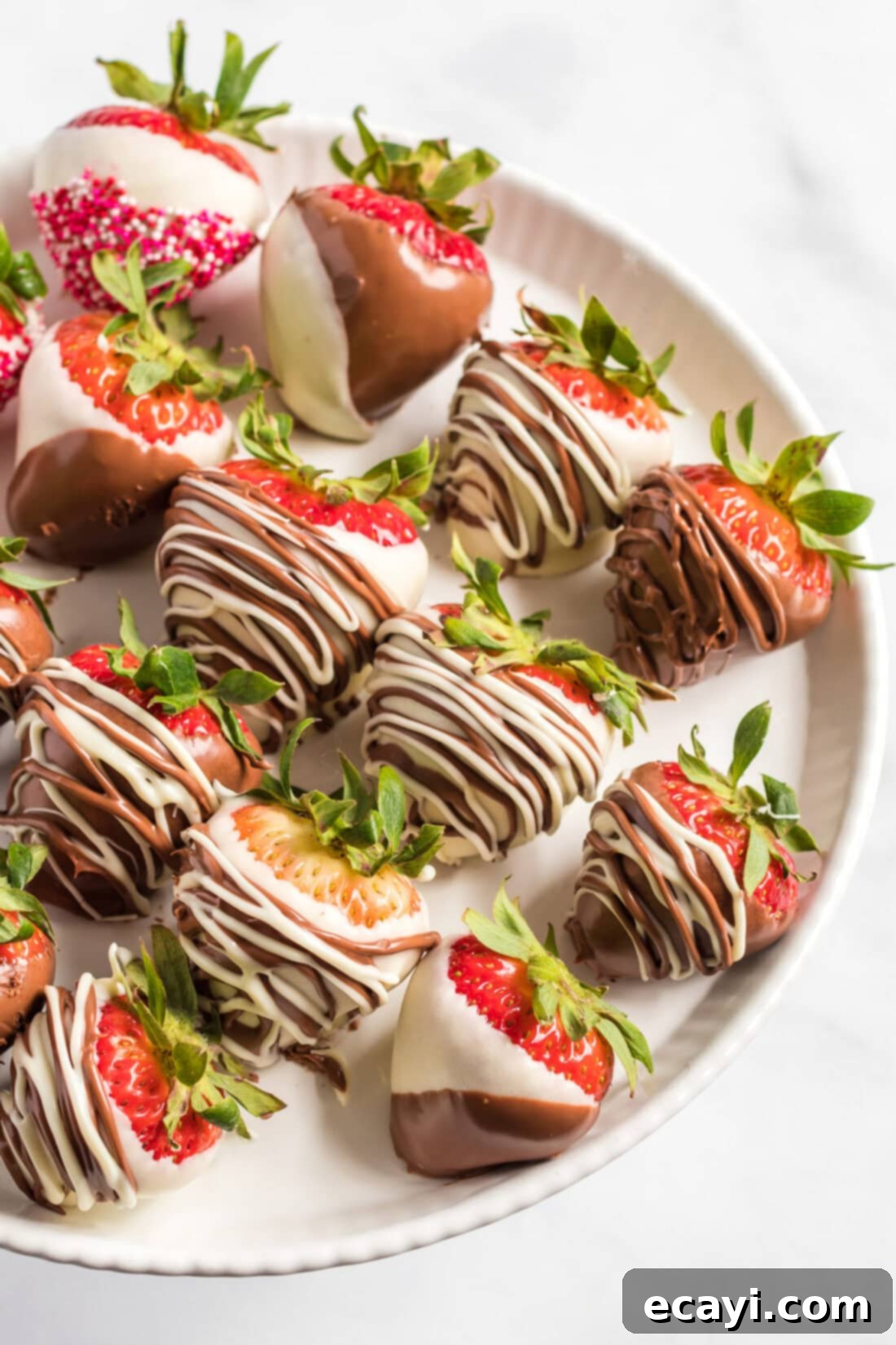 Indulgent Chocolate-Dipped Strawberries 2 Close up photo of a plate of perfectly glazed Chocolate Covered Strawberries