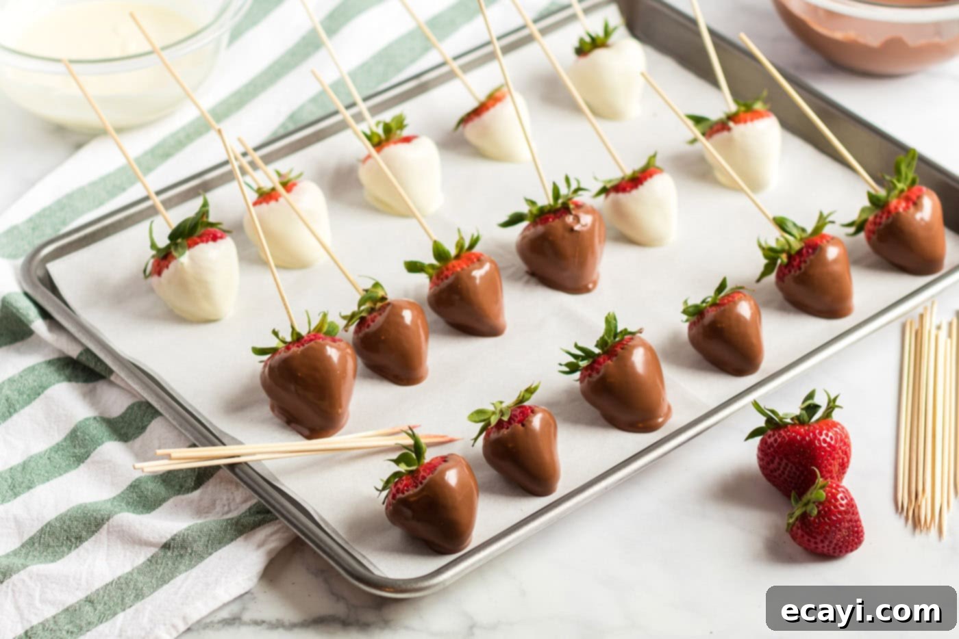 Indulgent Chocolate-Dipped Strawberries 7 dipped strawberries lined up on a pan
