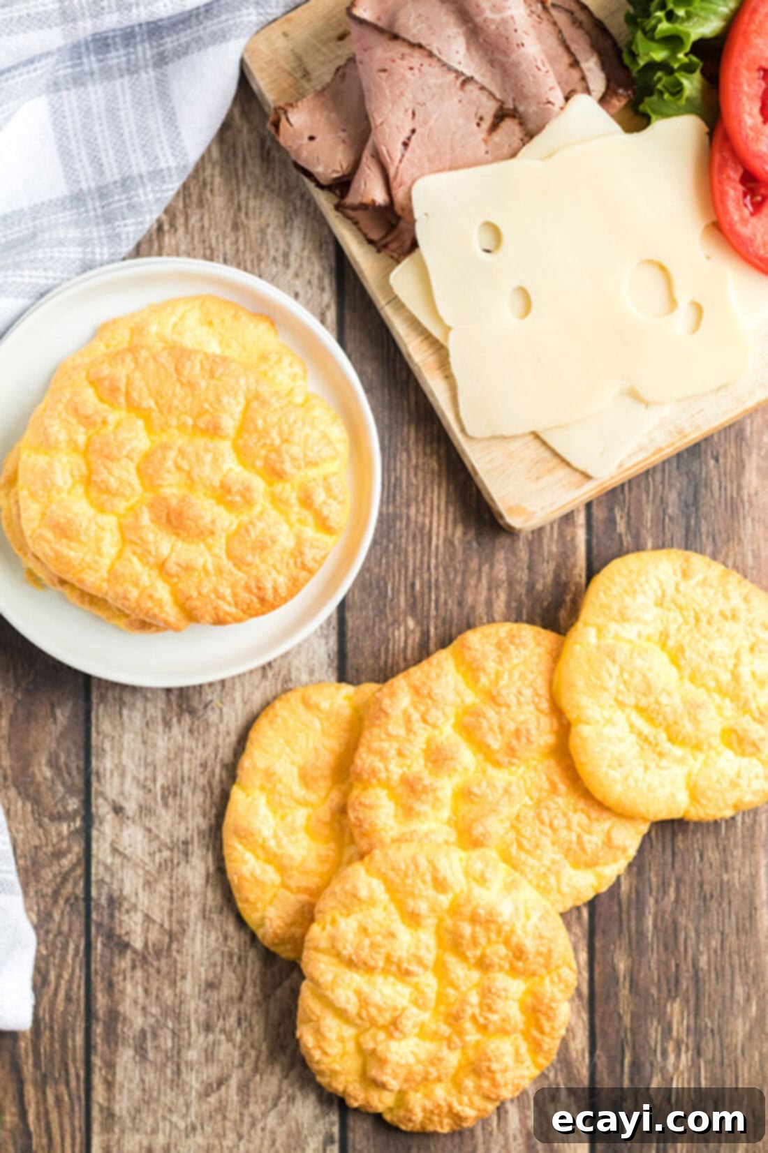 Airy Cloud Dream 3 Freshly baked cloud bread scattered on a rustic wood table, ready for use in keto-friendly meals