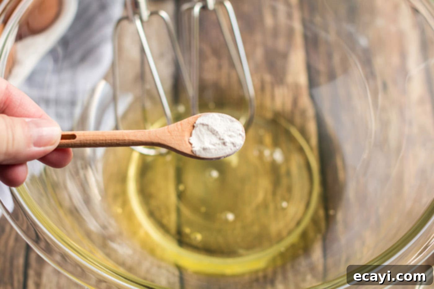 Airy Cloud Dream 4 Cream of tartar being added into a bowl of egg whites, preparing for whipping
