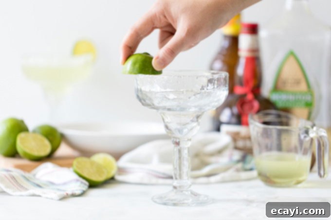 The Margarita Enigma 3 rubbing lime on a glass rim for salt