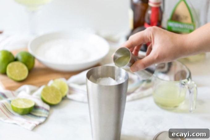 The Margarita Enigma 6 adding tequila to a cocktail shaker to make a margarita