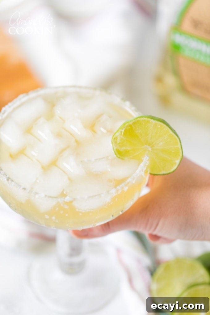The Margarita Enigma 7 hand holding a margarita on the rocks