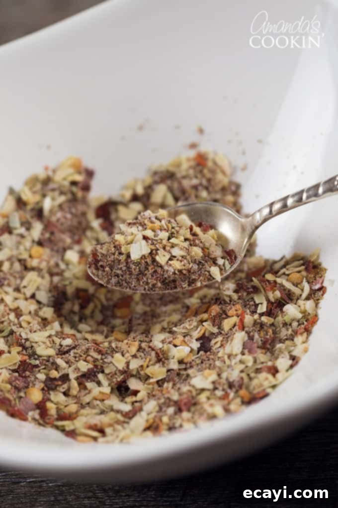 Once you taste this incredible homemade taco seasoning mix, you'll say goodbye to those bland store-bought options forever! A spoon overflowing with fragrant homemade taco seasoning mix, ready to flavor ground meat