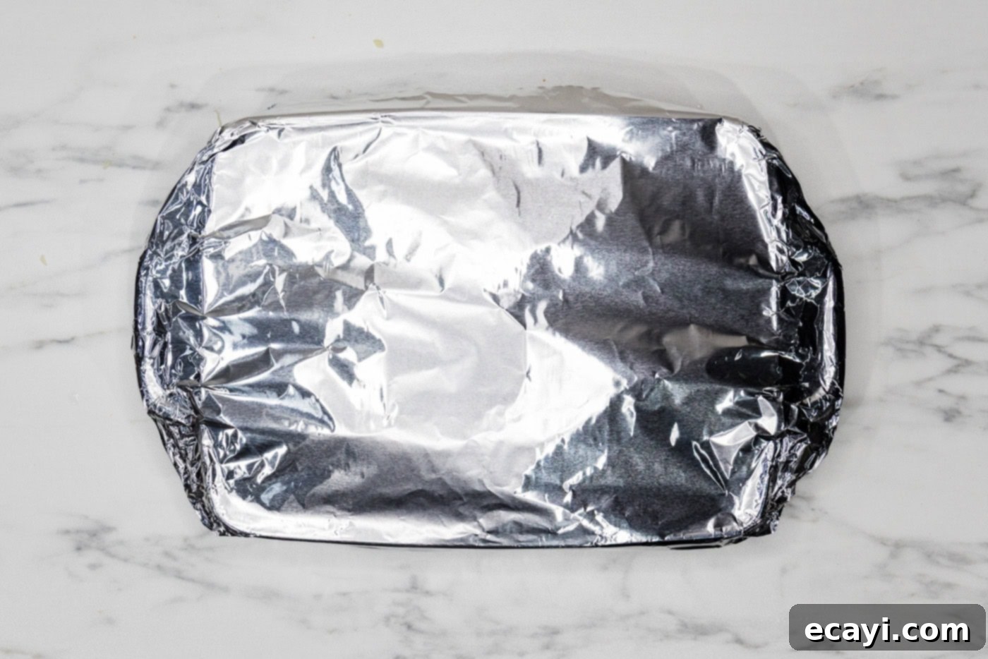 Classic Italian Lasagna 13 An overhead view of the lasagna baking dish, securely covered with aluminum foil, ready for its initial bake in the oven.