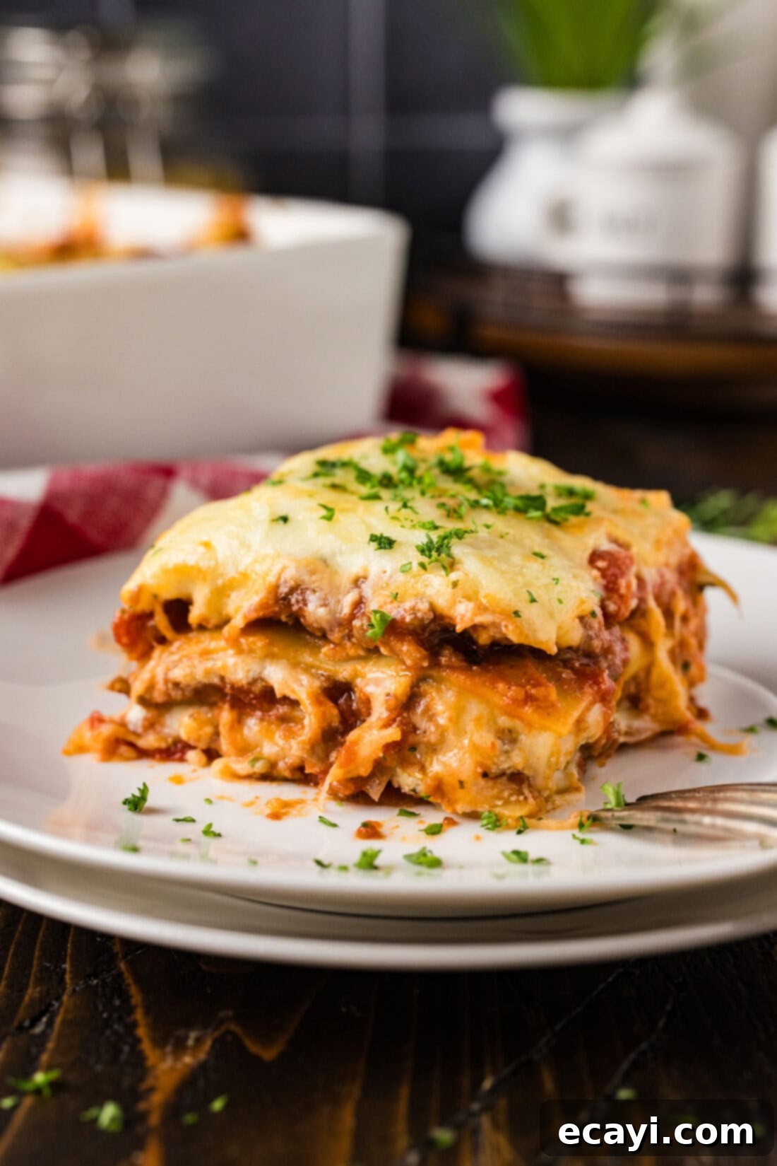 Classic Italian Lasagna 14 A perfectly portioned slice of golden-brown Italian Lasagna, glistening with melted cheese and rich meat sauce, served on a white plate, ready to be enjoyed.