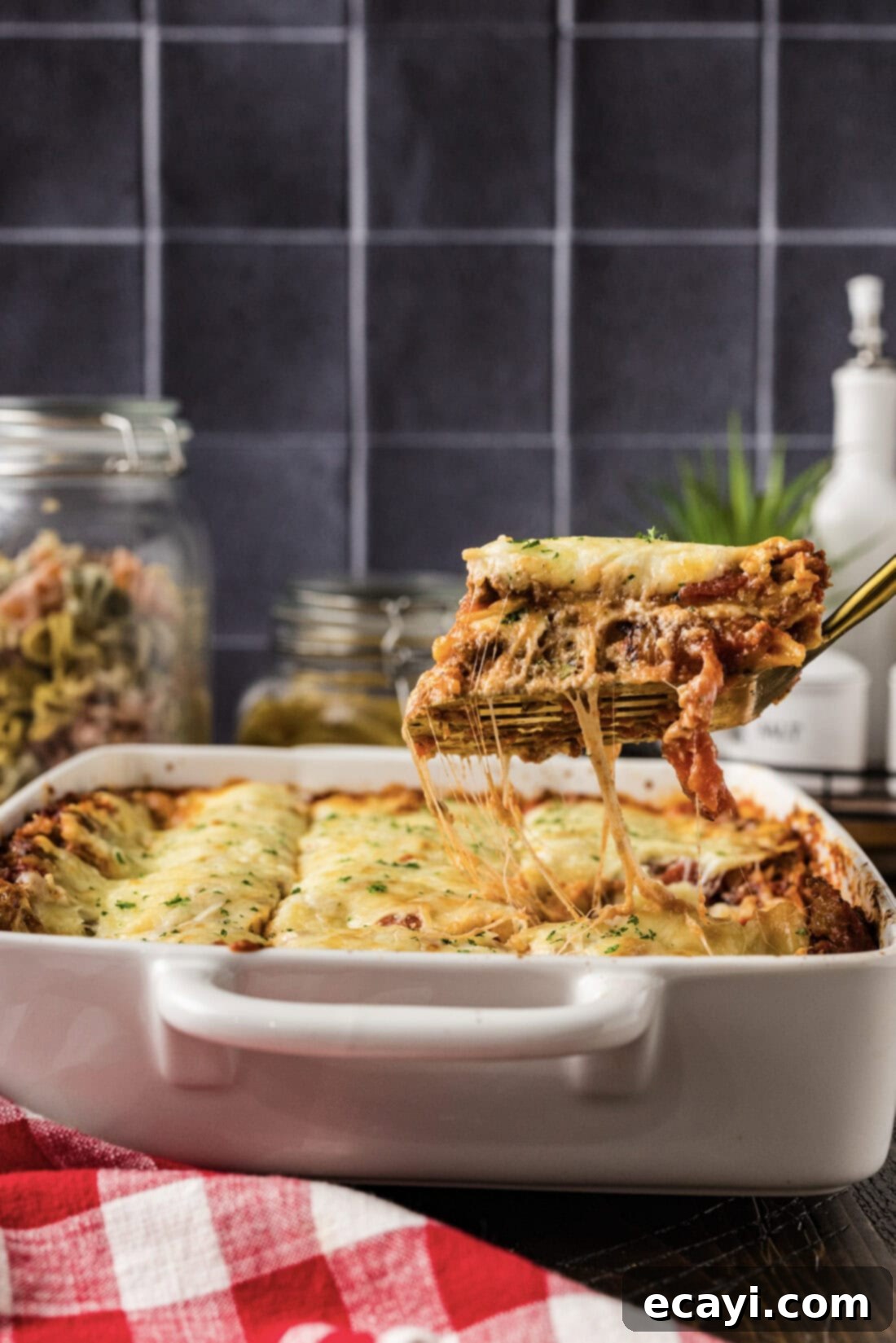 Classic Italian Lasagna 4 A sturdy spatula carefully lifting a perfect, cheesy slice of homemade Italian Lasagna from the baking pan, highlighting its layers and golden-brown top.