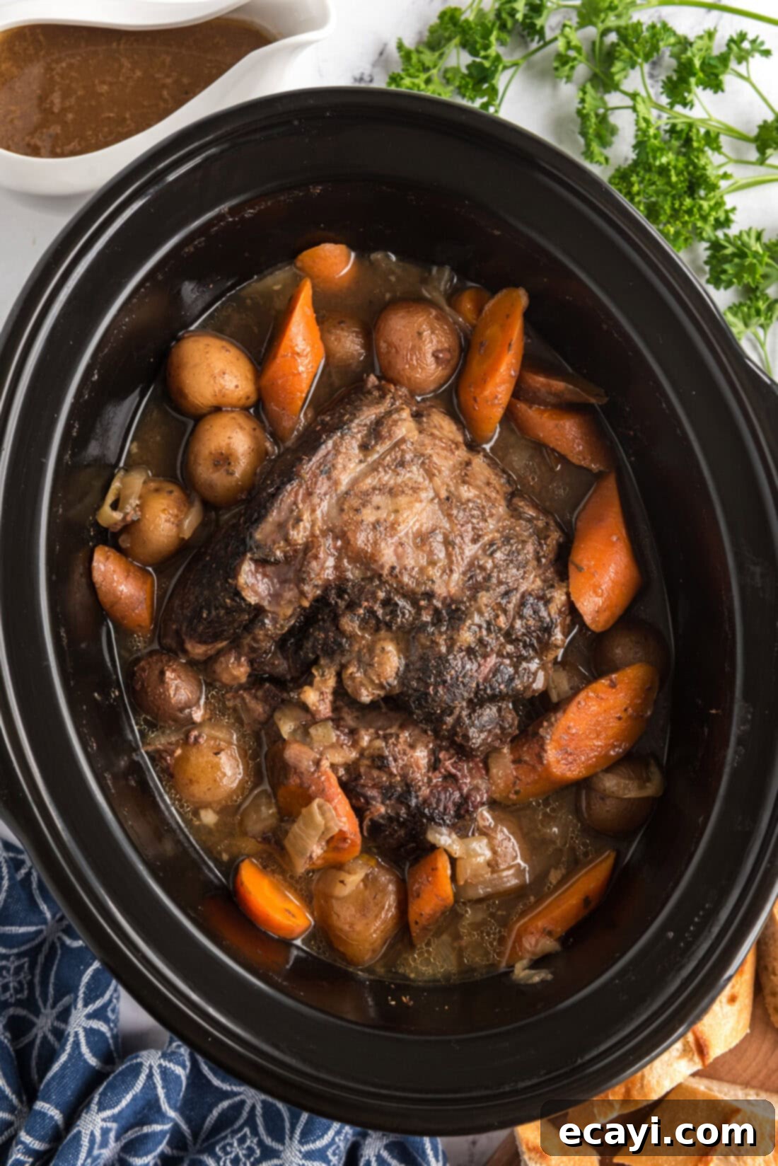 Melt-in-Your-Mouth Slow Cooker Pot Roast 2 Crockpot Roast Beef in a crockpot, showcasing the tender meat and vegetables cooking slowly