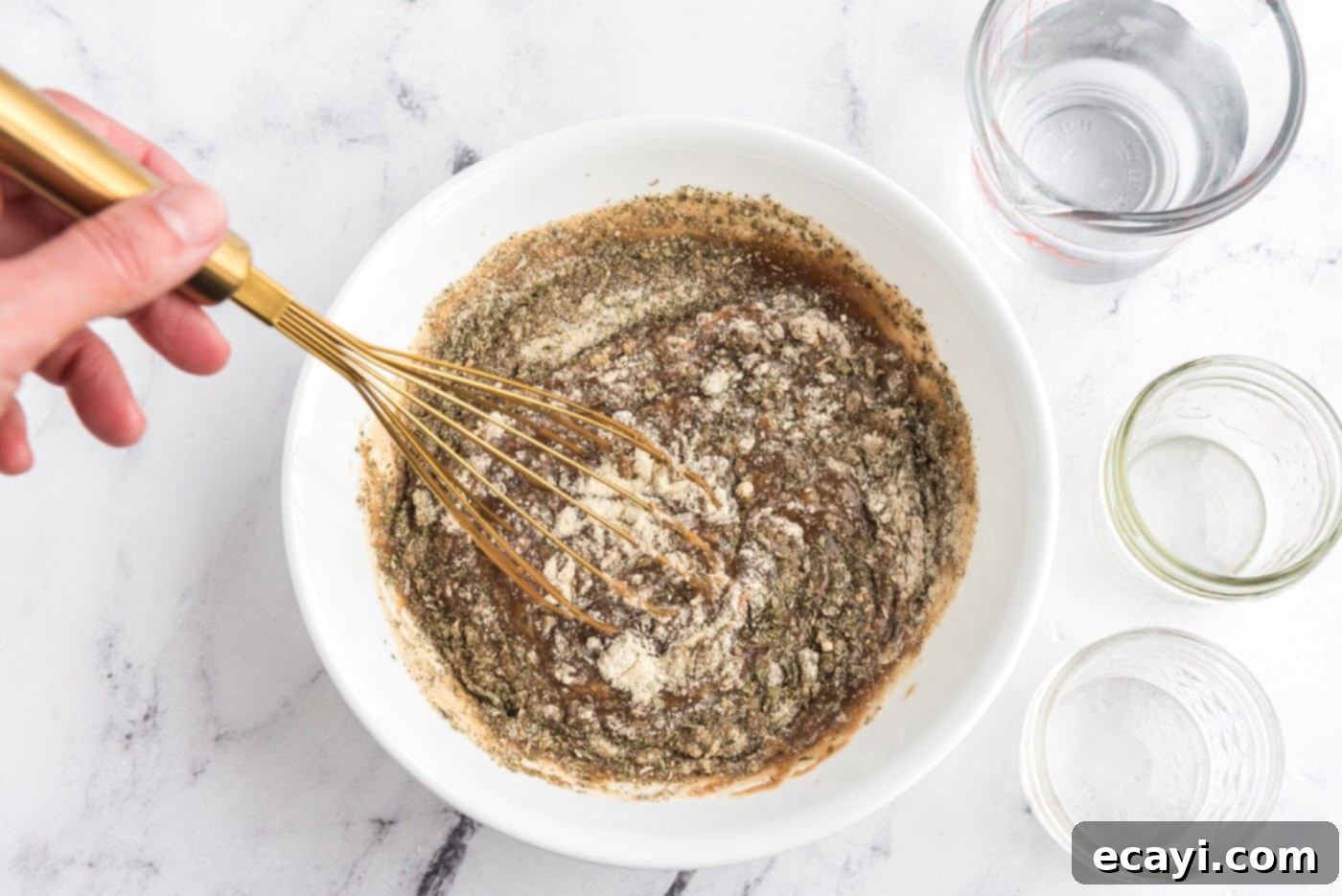 Melt-in-Your-Mouth Slow Cooker Pot Roast 8 Whisking beef gravy, ranch dressing mix, and Italian dressing mix in a bowl