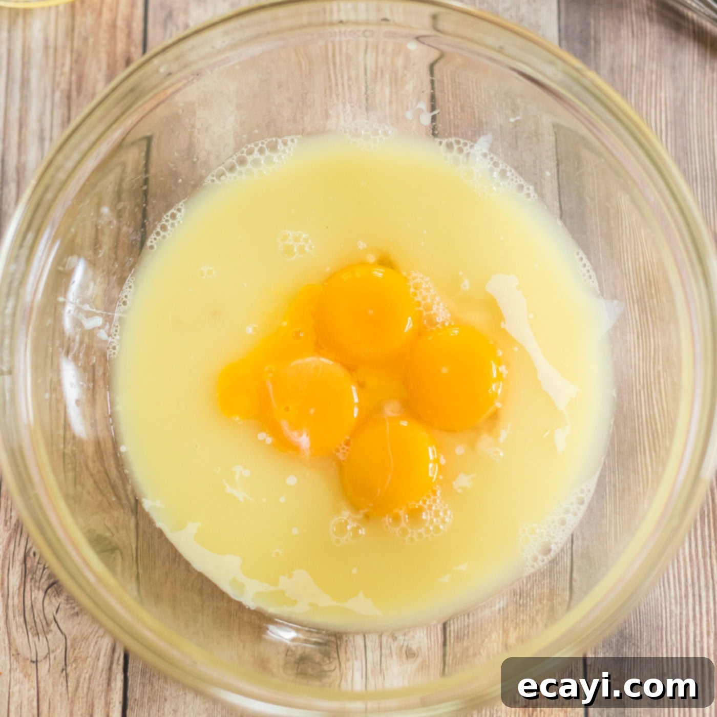 Classic Key Lime Pie 6 egg yolks in bowl with sweetened condensed milk