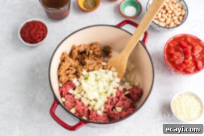 Hearty Ground Beef & Vegetable Stew 7 pot with ground beef, italian sausage, and onion browning