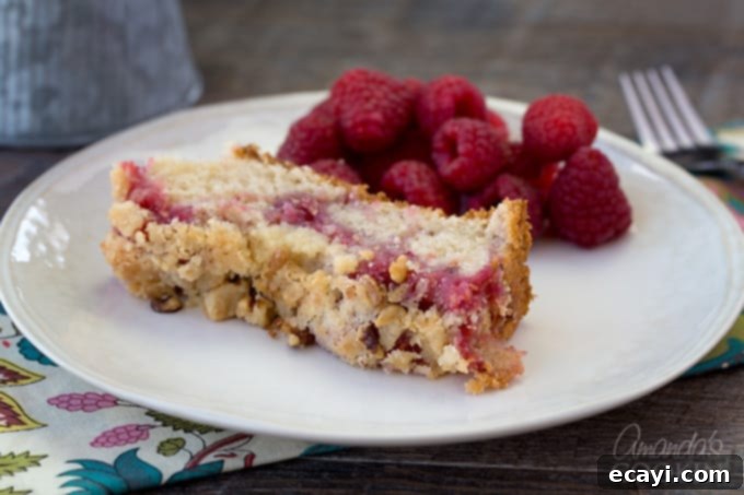 Tangy Raspberry Swirl Coffee Cake 11 Scrumptious raspberry coffee cake with a vibrant fruit filling and a delightful crumb topping, served fresh.
