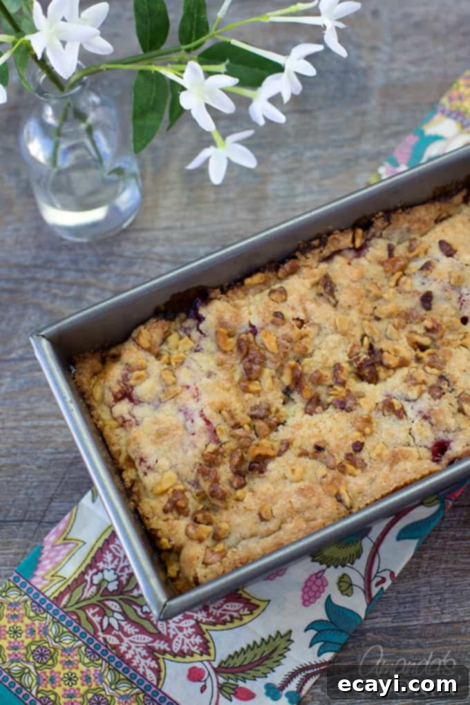Tangy Raspberry Swirl Coffee Cake 9 A delicious raspberry coffee cake cooling on a wire rack, filling the air with its sweet and fruity aroma.