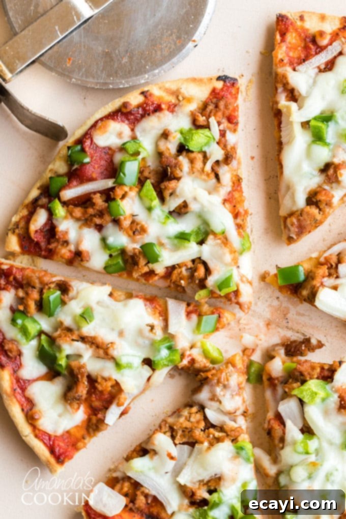 Easy Homemade Pizza Sausage: The Secret to Perfect Pizza Toppings Slices of homemade pizza with generous portions of sausage and vibrant green bell peppers, showcasing the delicious result of the homemade pizza sausage recipe