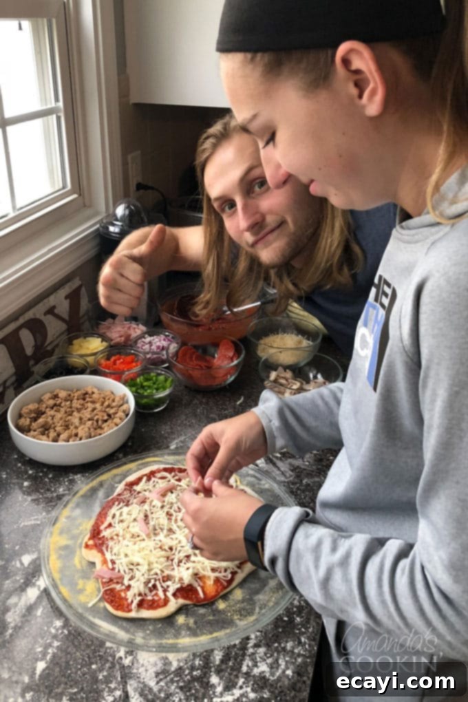 Crafting Authentic Pizza Sausage 3 Two children, Dominic and Lindsay, smiling as they carefully arrange toppings on their individual personal pan pizzas, engaged in a fun homemade pizza making session.