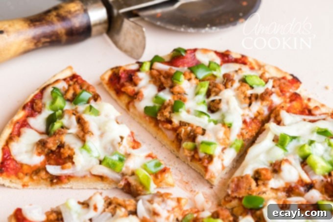 Crafting Authentic Pizza Sausage 5 A perfectly sliced homemade pizza with a shiny pizza wheel resting in the background, ready for serving.