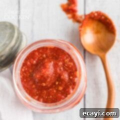 Pizza's Flavor Foundation 7 overhead view of jar of pizza sauce with spoon on the side
