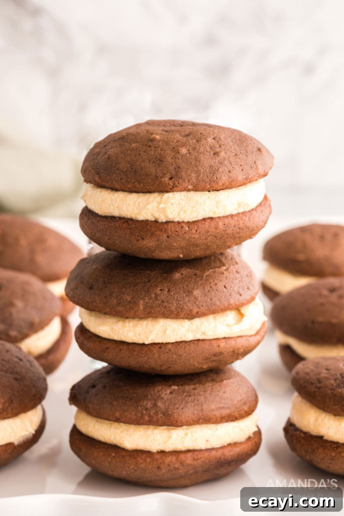 A beautiful stack of finished mini pumpkin whoopie pies, showcasing their delicious filling and inviting appearance. a perfect stack of mini pumpkin whoopie pies, ready to be served as a delightful fall dessert