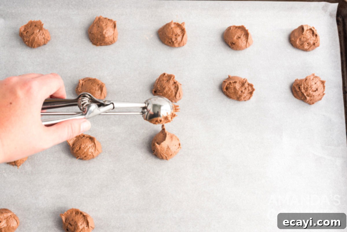 Pumpkin Spice Whoopie Bites 6 scooping dough onto a parchment-lined cookie sheet for whoopie pies