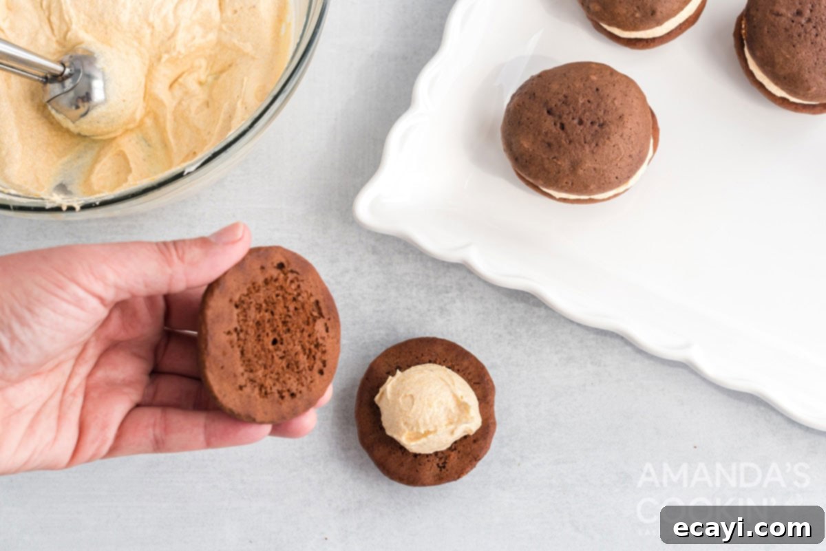 Pumpkin Spice Whoopie Bites 8 assembling a whoopie pie by placing the top cookie onto the pumpkin cream cheese filling