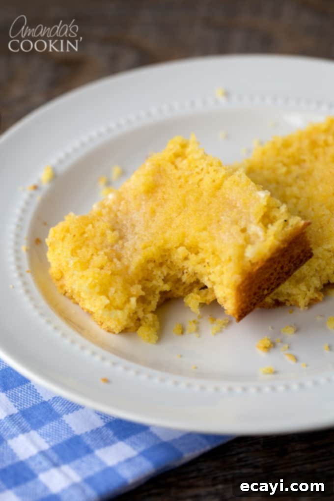 Honey-Kissed Cornbread 2 A piece of cornbread with a bite taken out of it, showing its moist and tender texture