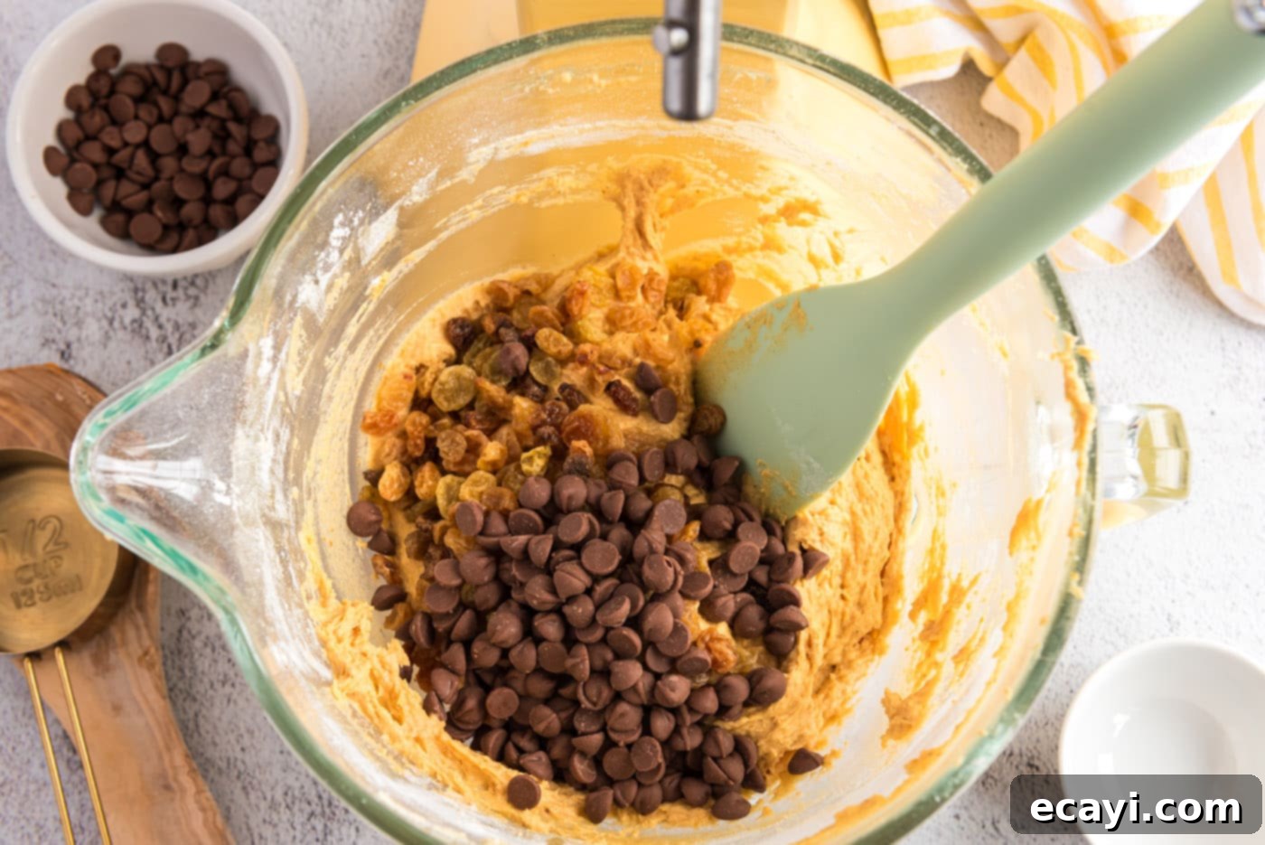 Spiced Pumpkin Chocolate Chip Muffins 15 Adding chocolate chips and golden raisins to the pumpkin muffin batter