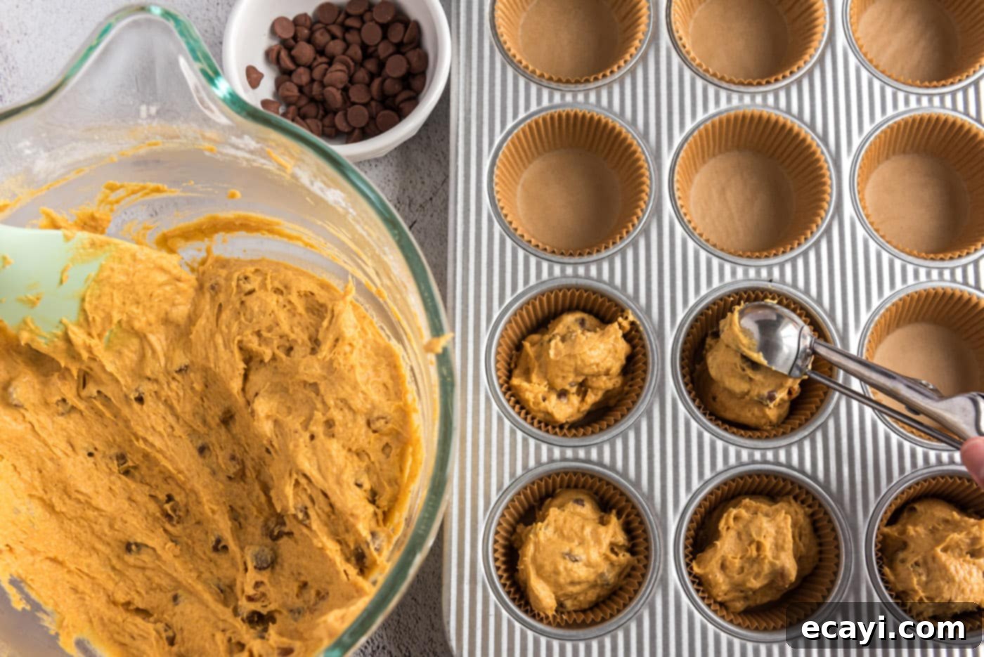 Spiced Pumpkin Chocolate Chip Muffins 16 Scooping pumpkin muffin dough into the prepared muffin pan cavities