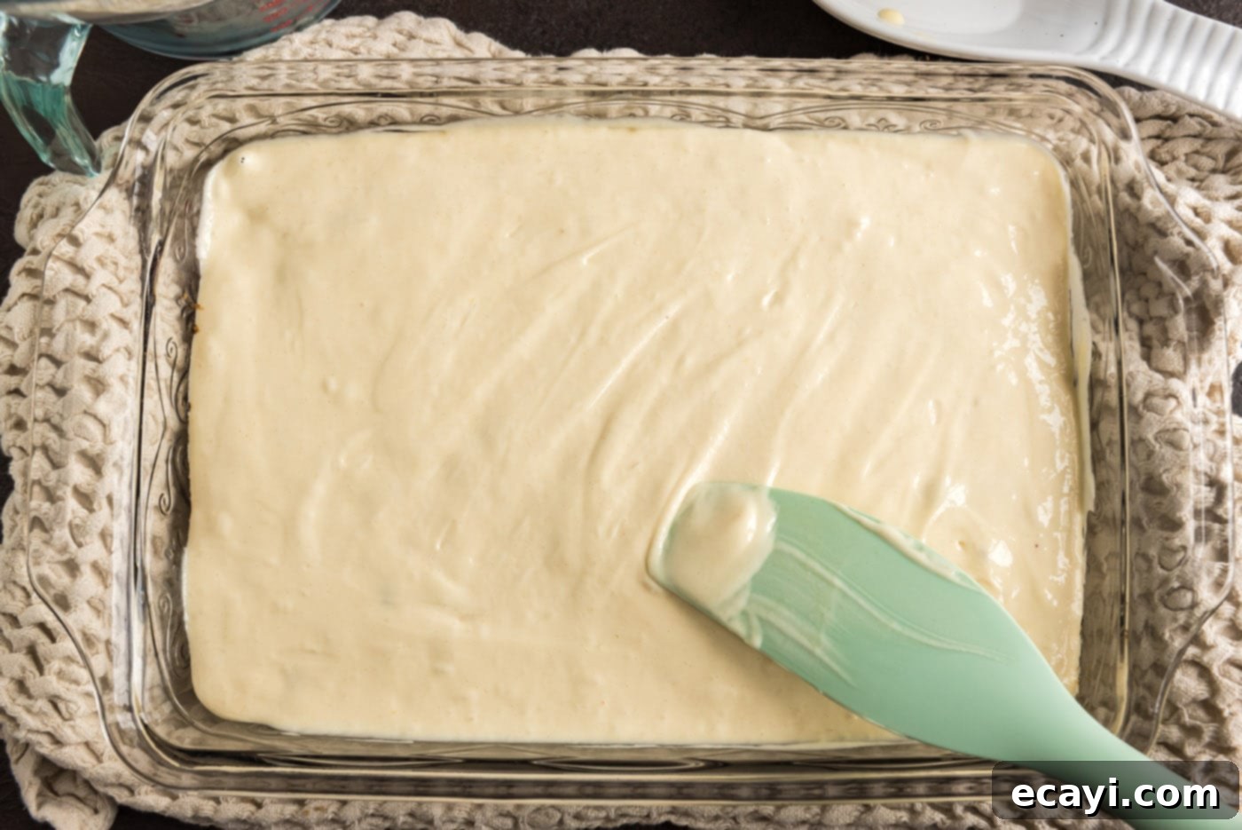 Ruby Raspberry Reveal 11 spreading cake batter over raspberries and brown sugar mixture