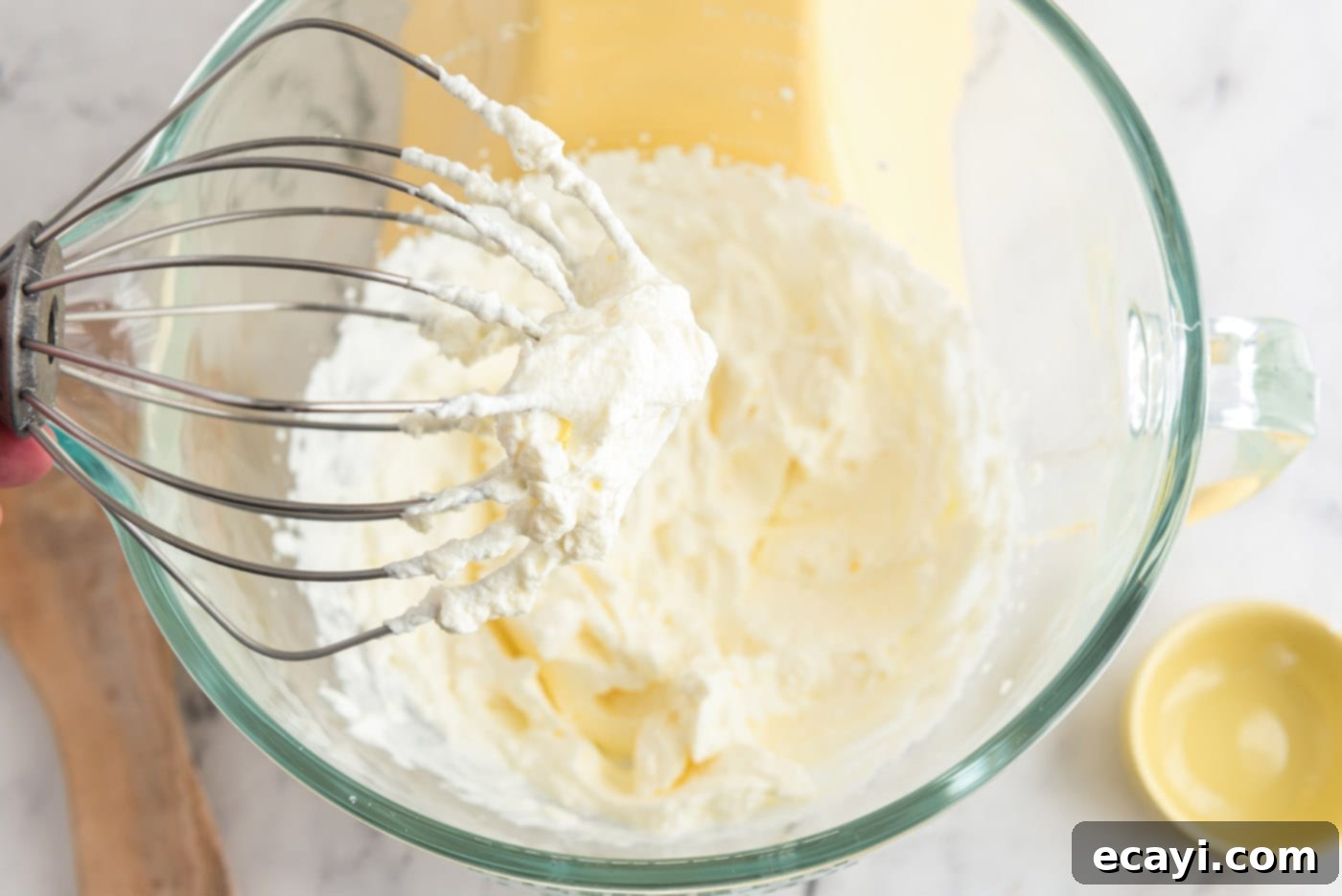 Silky Chocolate Dream 13 Homemade whipped cream in a stand mixer bowl, showing stiff peaks on the whisk attachment