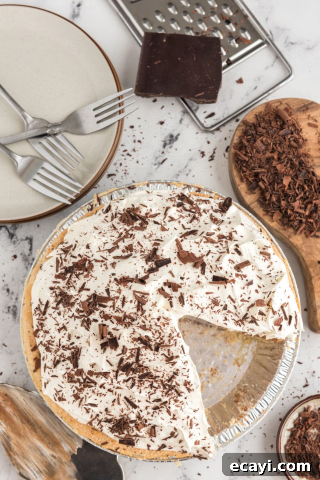 Silky Chocolate Dream 16 An overhead shot of a freshly made French Silk Pie, with one slice carefully removed to reveal the deep chocolate filling and perfect whipped cream swirl. A perfect display of this no-bake dessert.