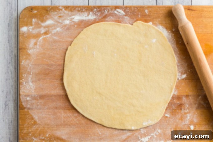 Whip Up Your Own Pizza Dough 11 rolled out pizza dough on a wooden board