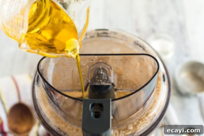 Whip Up Your Own Pizza Dough 7 adding olive oil to food processor with dough ingredients