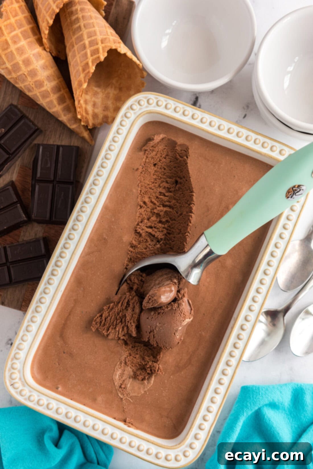 Decadent Homemade Chocolate Ice Cream 2 Container of Homemade Chocolate Ice Cream with an ice cream scooper in it, ready to be served
