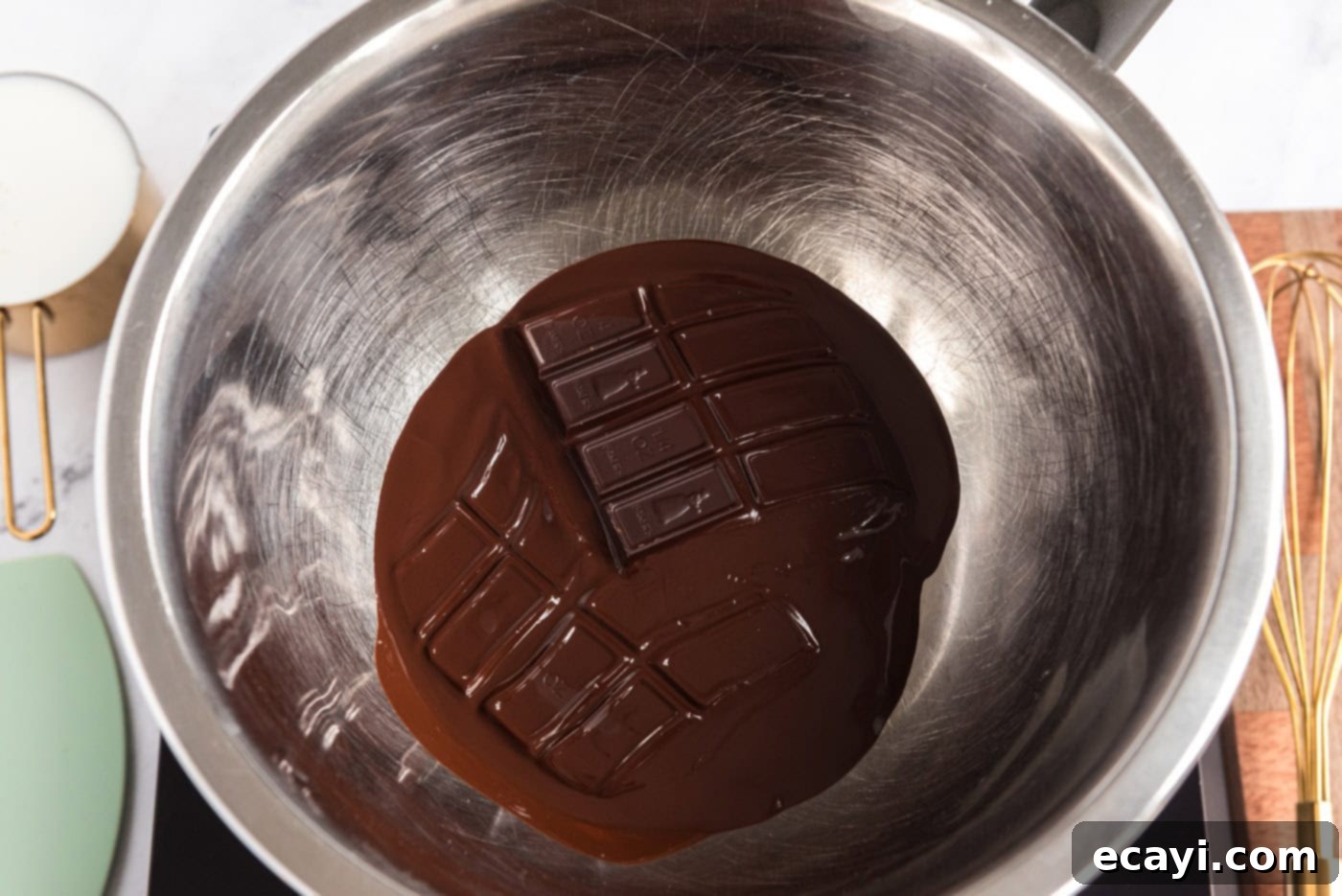 Decadent Homemade Chocolate Ice Cream 5 Melting unsweetened chocolate bars in a bowl over hot water in a double boiler setup