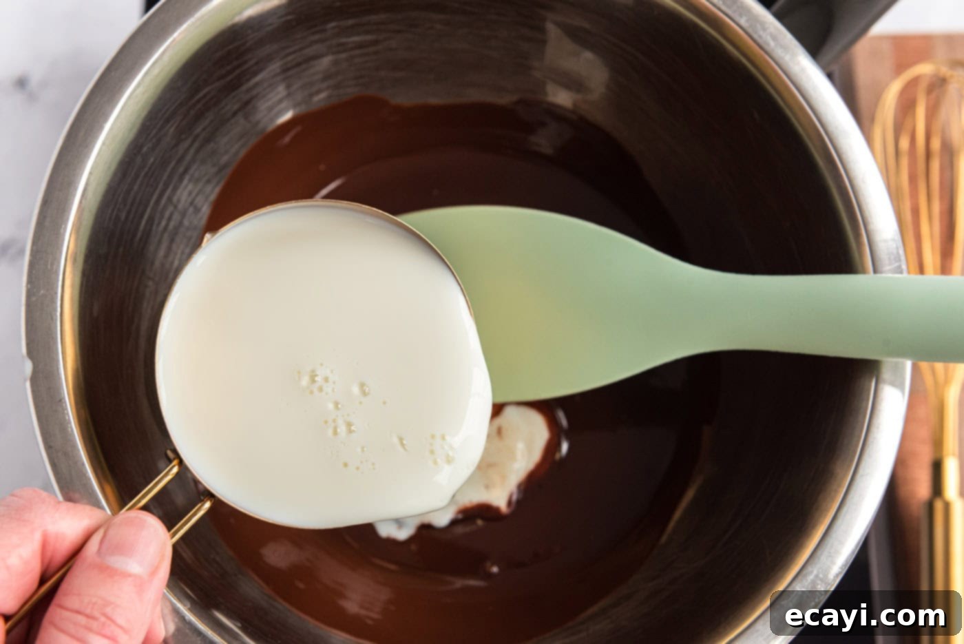 Decadent Homemade Chocolate Ice Cream 6 Whisking milk into melted unsweetened chocolate in a large bowl over heat on a double boiler