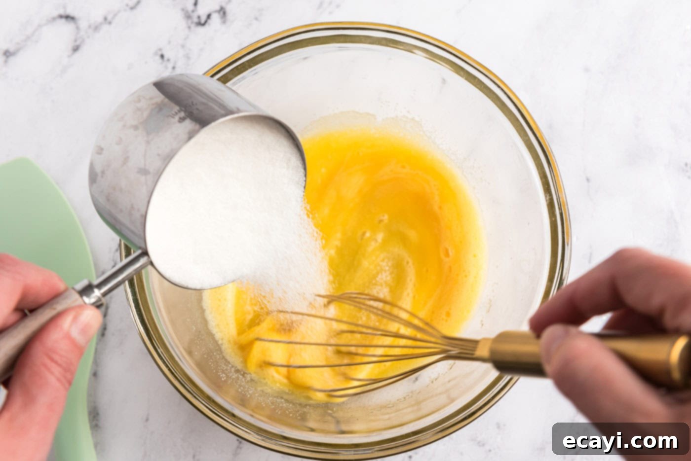 Decadent Homemade Chocolate Ice Cream 8 Whisking granulated sugar into beaten eggs in a mixing bowl until light and fluffy
