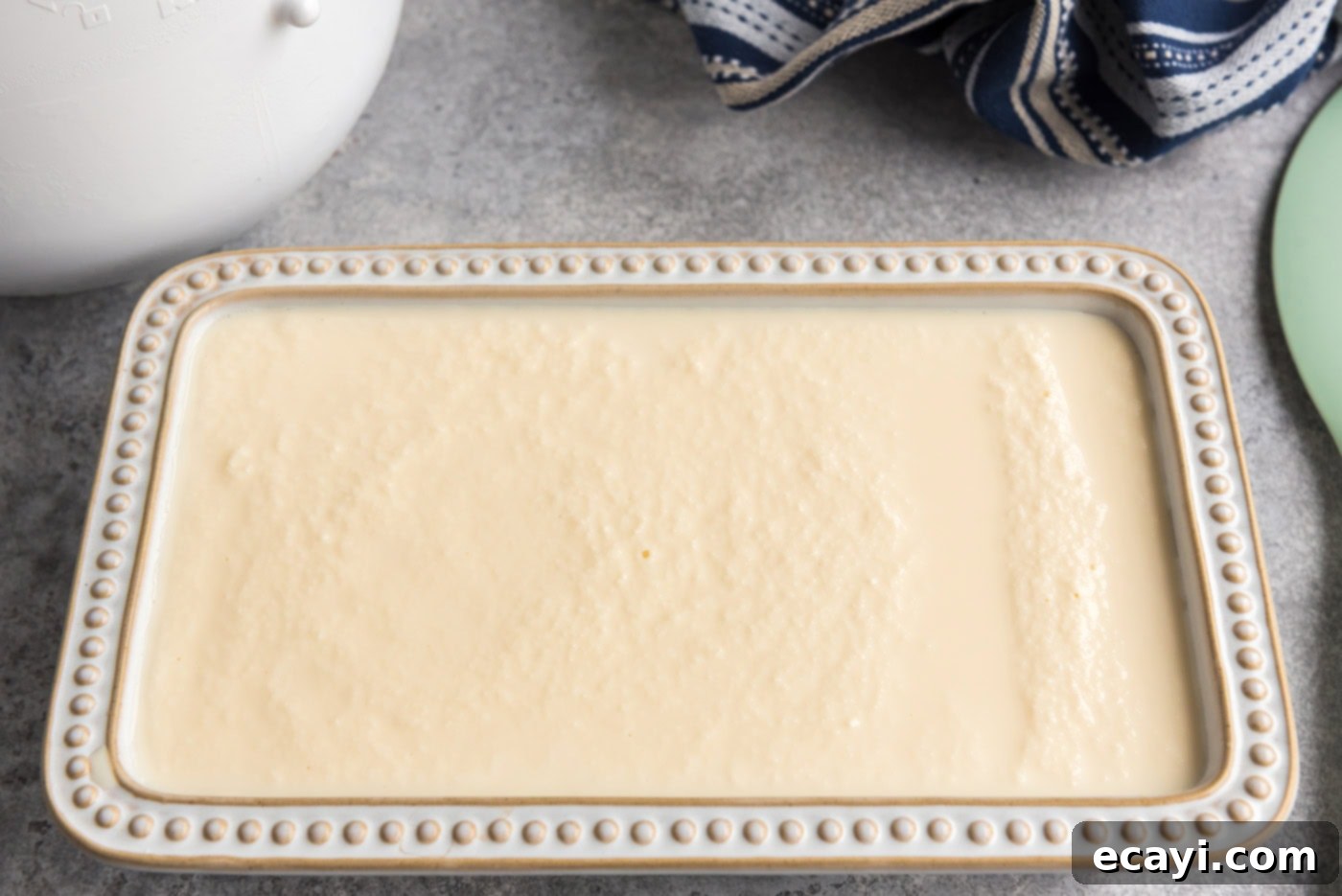 The Ultimate Homemade Vanilla Ice Cream 11 ice cream mixture poured into a container