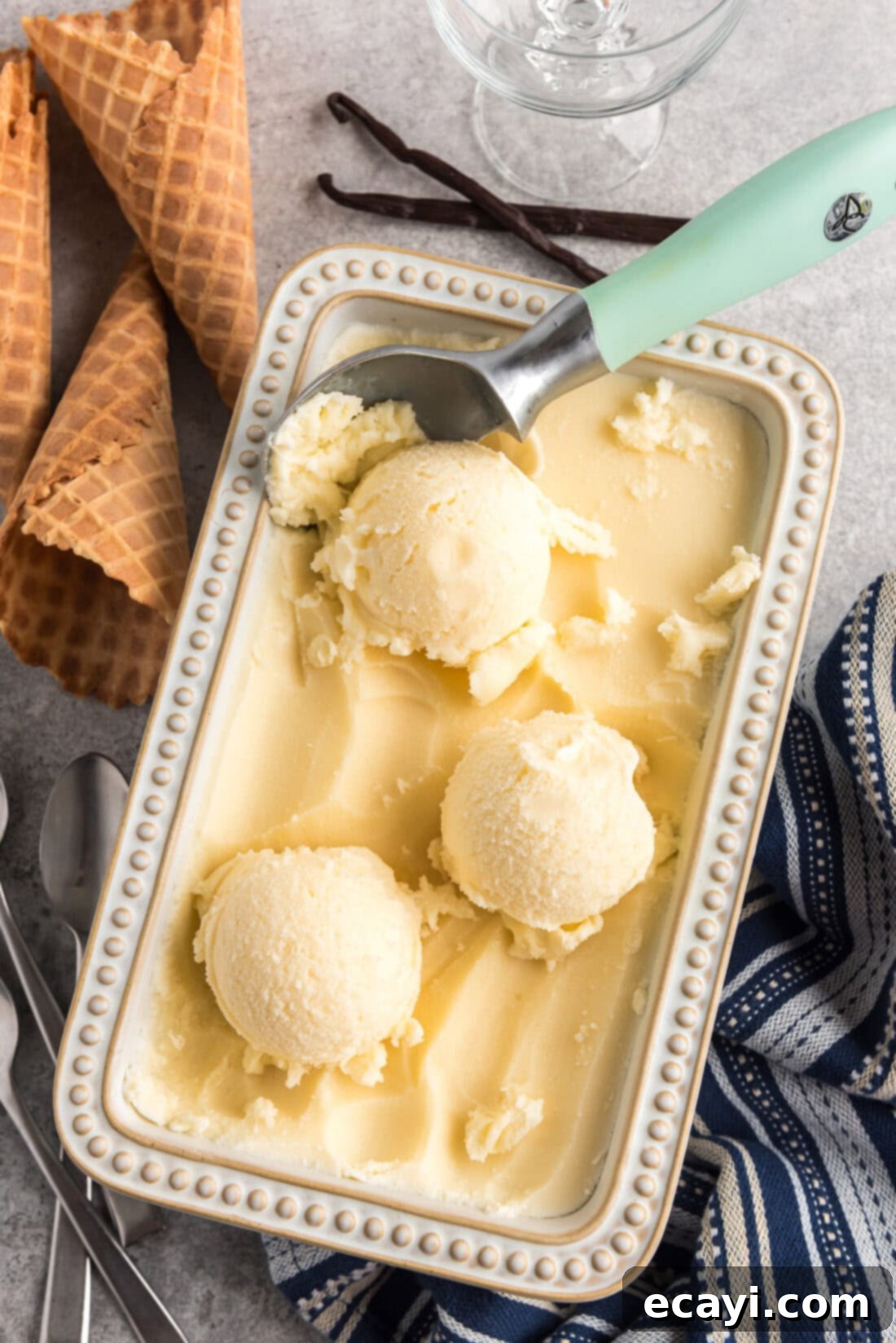 The Ultimate Homemade Vanilla Ice Cream 3 Scoops of Homemade Vanilla Ice Cream in a container
