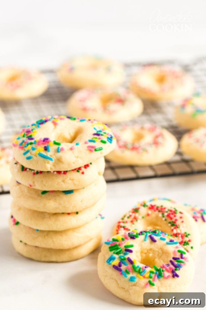A delicious buttery sugar cookie with a pretty presentation. These soft cookies would be great for a birthday party, Cinco de Mayo celebrations, or just when you want a chewy sugar cookie. stack of Mexican cookies with sprinkles