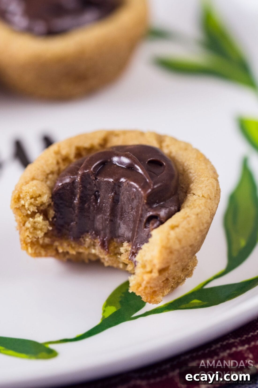 Fudgy Peanut Butter Delights 7 Detailed close-up of a peanut butter fudge cookie cup, highlighting its soft texture and rich chocolate center